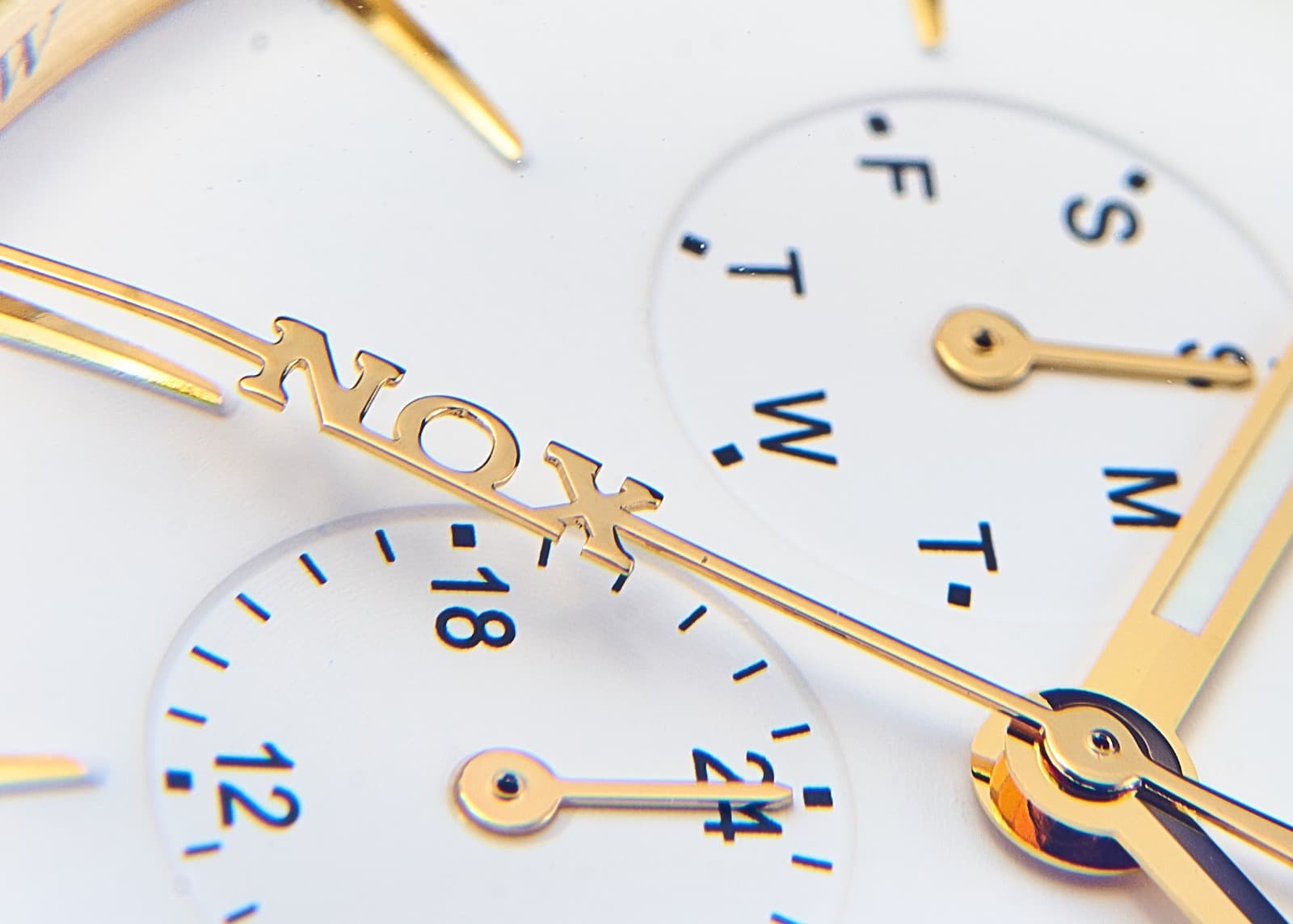 Macro detail of a custom NOX watch dial with day and date subdials