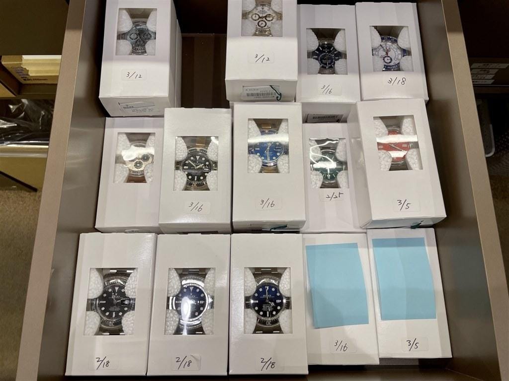 Drawer of boxed watches in wholesale inventory