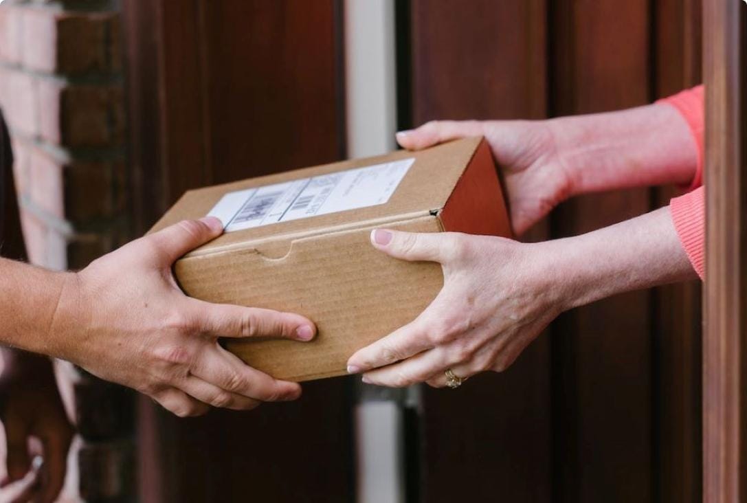 Courier handing over a delivered watch parcel