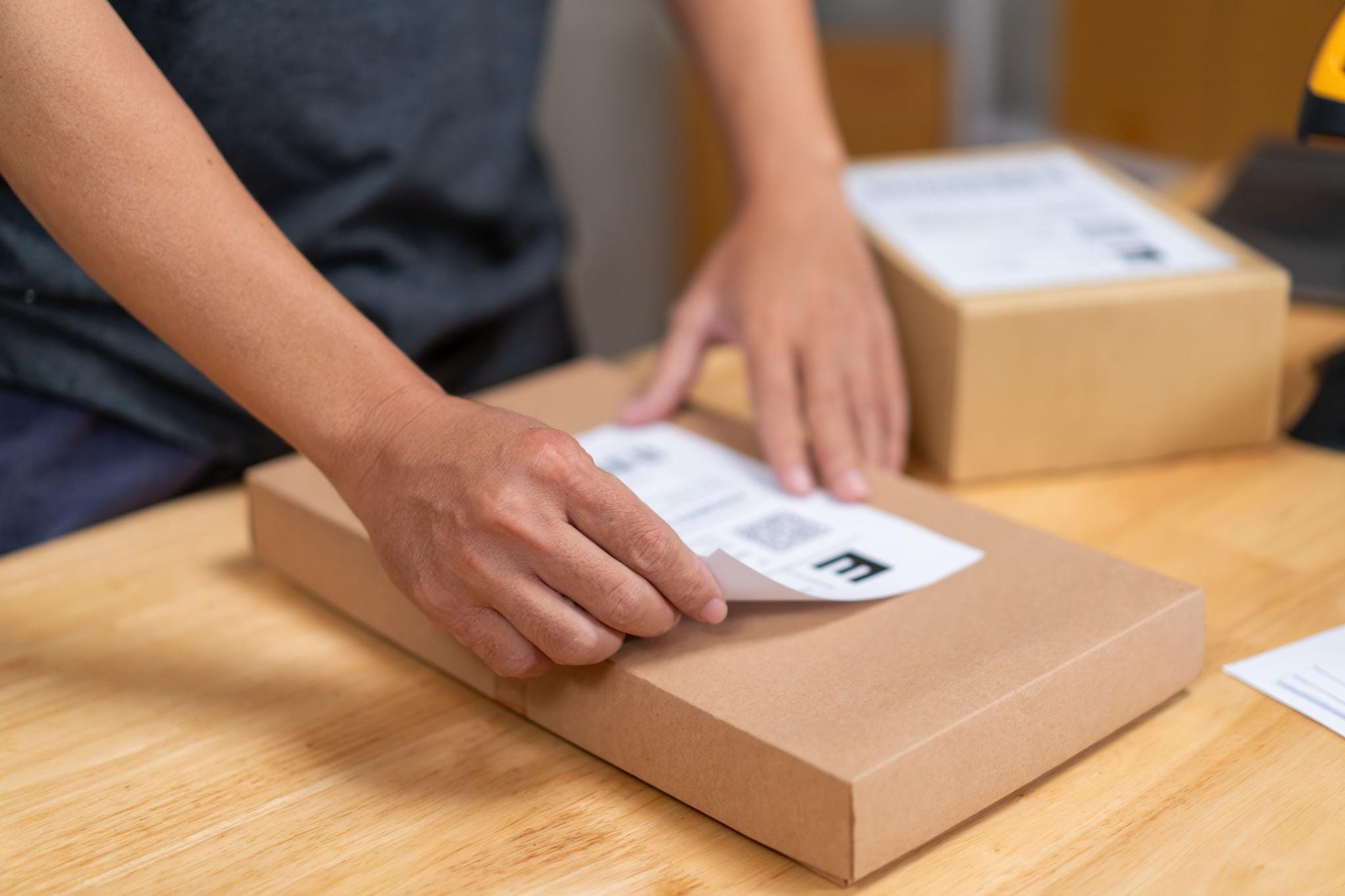 Packing a watch parcel with a shipping label for direct-to-customer delivery